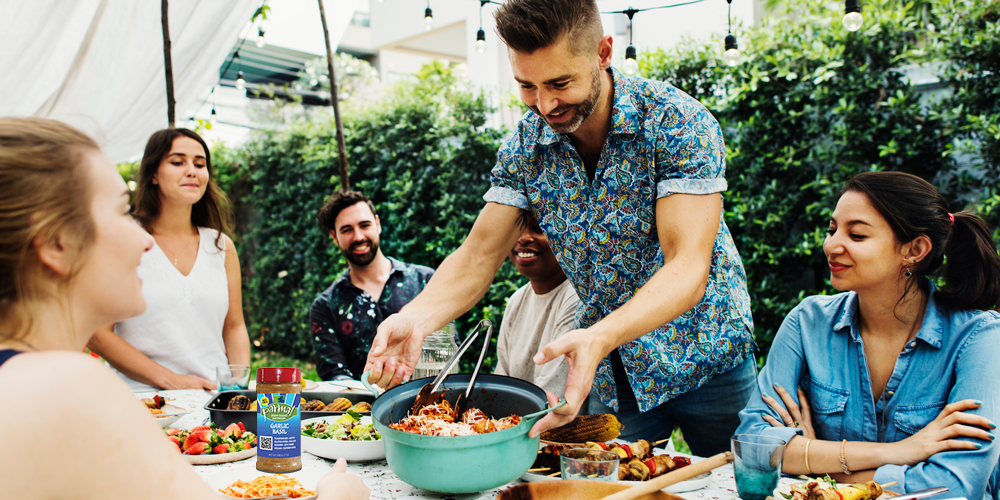 Friends enjoying an outdoor picnic with delicious recipes featuring parma plant based parmesan